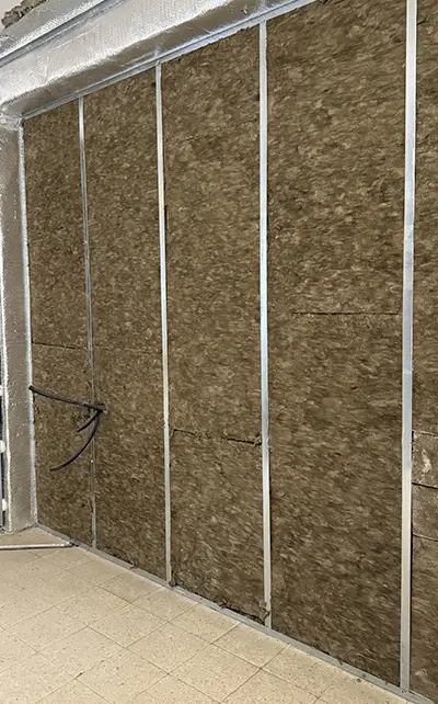 Insulation Barcelona project with mineral wool thermal and acoustic insulation installed inside interior wall metal studs
