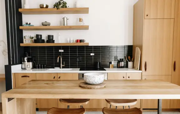 Mediterranean traditional kitchen with warm wood cabinets, open shelving and black subway tile backsplash