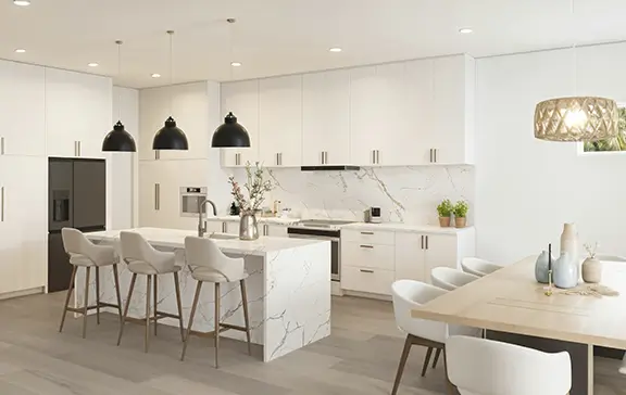 Modern minimalist kitchen remodel in Barcelona with white handleless cabinets, marble island, bar stools and black pendant lights