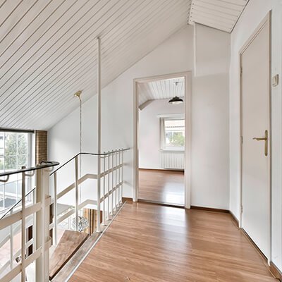 Bright renovated upper-floor hallway in a Barcelona home with insulated walls, ceiling and windows for better thermal and acoustic comfort by Revive Quality
